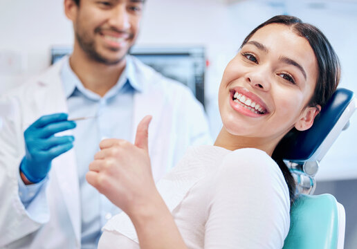 Delaware Star Dental patient smiling and giving a thumbs up during a root canal visit